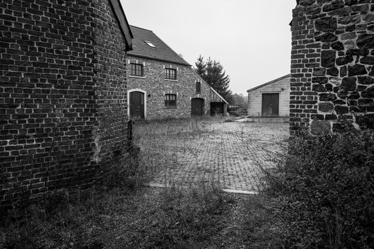 Old farm house and sheds in Belgium, region Liege nearby Gemmenich  and Sippenaeken, picture taken in black and white