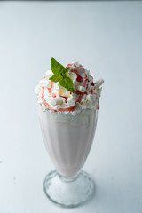 Classic vanilla milkshake with whipped cream isolated on white flat lay top view