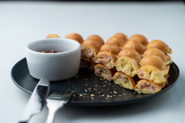 Hong Kong bubble waffle with sausage and cheese on white flat lay