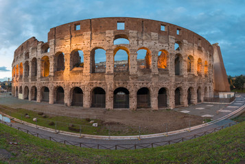 Fototapeta premium panoramic of the backside of the Roman Colosseum illuminated at sunset