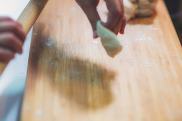 Woman prepare dumpling skin, Making dough  on wooden table