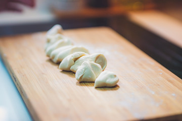 Fototapeta na wymiar Woman prepare dumpling skin, Making dough on wooden table