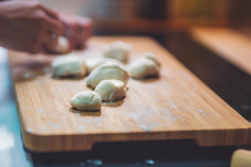 Woman prepare dumpling skin, Making dough  on wooden table
