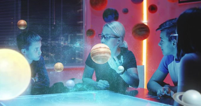 Teacher giving a class with holographic solar system