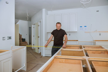 Man using tape measure for measuring on kitchen in for home improvement.