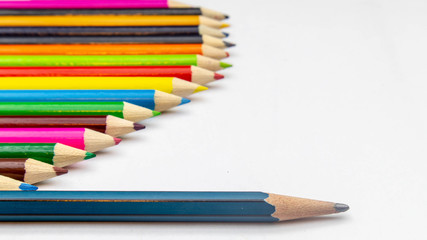 Many colored pencils, arranged in beautiful orderly on a white background