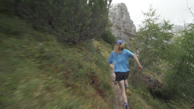Fast Trail running follow shot cross country on a mountain in the alps, Ultra trail, epic runner trail run in 4K