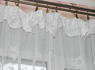 White tulle on the window curtain.