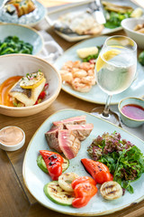 Medium rare tuna with lettuce and hot sauce. Restaurant menu. Variety of dishes on the table. Restaurant menu. Italian cuisine