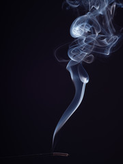 Abstract cloud of white smoke swirling, isolated on black background, close up view. Structure of smoke, brush effect. Abstract background of burning incense. Fragrance for meditation