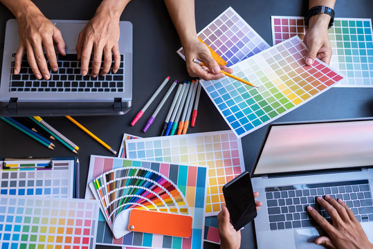 Top view of the hands of designers brainstorming of the business office.