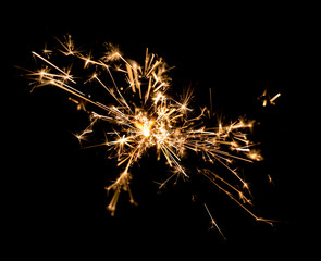 Fototapeta premium burning sparkler on dark background.