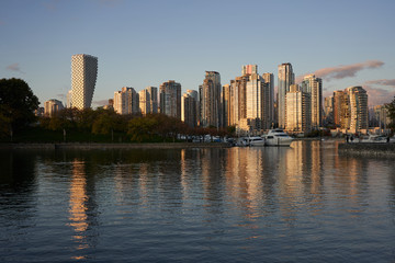 Fototapeta na wymiar False Creek waterfront buildings and boats during sunset in Vancouver, British Columbia, Canada.