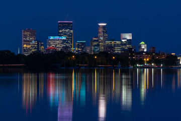 Fototapeta na wymiar Night light colors reflection of Downtown Minneapolis Minnesota on Lake Calhoun - Bde Maka Ska 