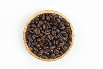 Coffee beans in wood bowl on white background with copy space. Design background
