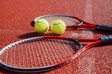 Low angle view tennis scene with balls and racquet