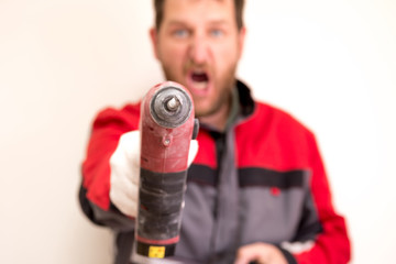 the screaming worker pointed the hammer at the camera