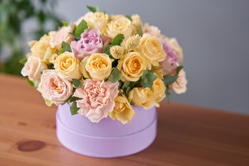 Floral shop concept . Flower arrangement in a round box. Beautiful bouquet of mixed flowers. Handsome fresh bunch. Flowers delivery