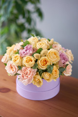Floral shop concept . Flower arrangement in a round box. Beautiful bouquet of mixed flowers. Handsome fresh bunch. Flowers delivery