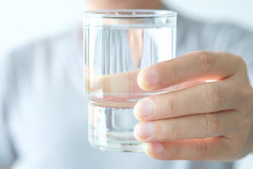 In the Morning, hand of man holding a clear glass of water for drinking.