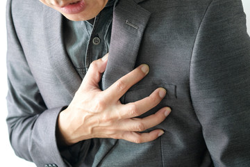 Heart attack, Man standing chest pain in the bedroom Health concept