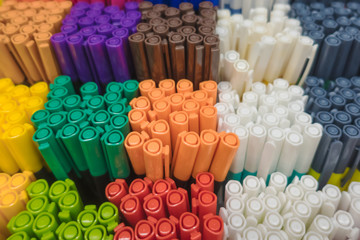 Close up on top view on variety of many colorful pens are in box on shelf stack sale point are in...