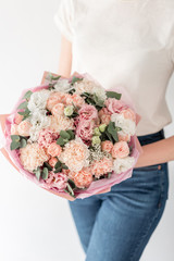 Beautiful bouquet of mixed flowers in womans hands. the work of the florist at a flower shop. Handsome fresh bouquet. Flowers delivery