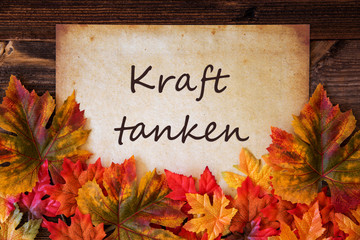 Grungy Old Paper With German Text Kraft Tanken Means Relax. Colorful Autum Decoration With Leaves