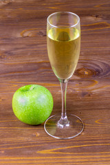 wineglass of fresh cider with green apple near close up , drink and fruit macro , wine in glass
