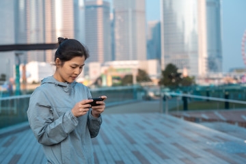 Fototapeta premium Woman playing mobile game outdoor