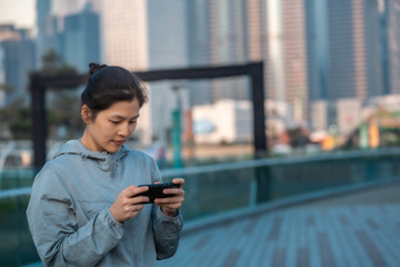 Fototapeta premium Woman playing mobile game outdoor