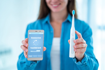 Wireless connection ultrasonic electric toothbrush with smart phone app. Modern home technology...