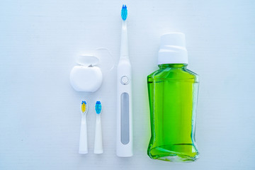Ultrasonic toothbrush and dental products for brushing teeth and oral hygiene on a white background.