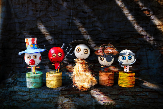 Halloween concept background, Cute little wooden ghost doll gang on abstract stone wall texture background, red devil with his ghost friends