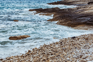 view of rocky sea beach in storm weather