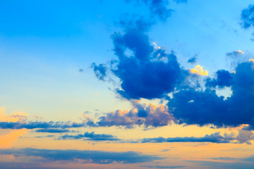 Naklejka na ściany i meble Bright cumulus clouds against the blue sky. Sunset sky Natural background