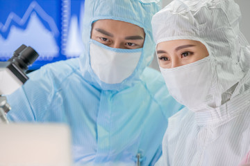 asian scientist with cleanroom suit