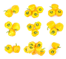 Set of fresh yellow bell peppers on white background, top view