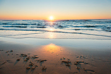 Sunset over the Atlantic Ocean on a sandy beach at Cap Ferret in France.
