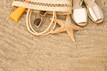 Composition with beach accessories on sand, top view. Space for text