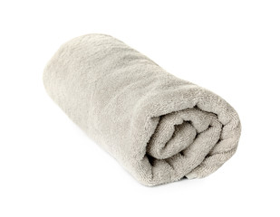 Fototapeta na wymiar Rolled clean beige towel on white background