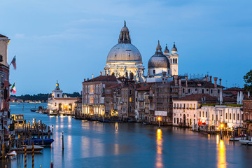 Long exposure of the Grand Canalat twilight with the Santa Maria della Salute cathedral in Venice in Italy