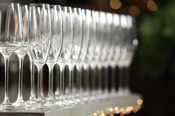 Set of empty glasses on grey table against blurred background