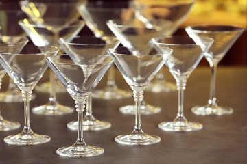 Empty martini glasses on table against blurred background