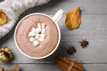 Flat lay composition with cup of hot drink on grey wooden table. Cozy autumn atmosphere