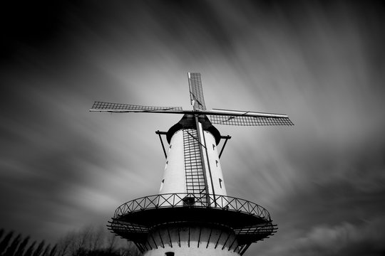 Black and white photo of windmill "the good hope" with a threatening cloudy sky in Menen - Belgium This scaffolding mill was founded in 1798 and was and is being used as a flour mill.