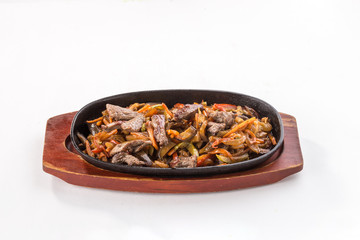 Beef fajitas with colorful vegetables in pan isolated on white background