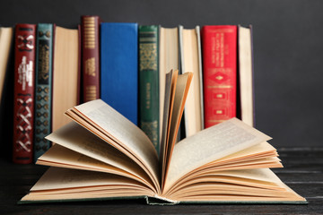 Open hardcover book on black wooden table