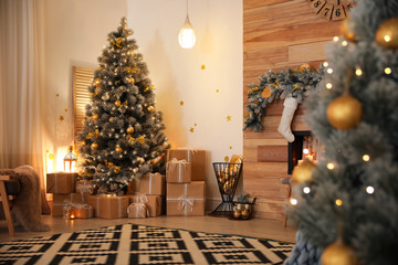 Stylish room interior with beautiful Christmas tree and gift boxes