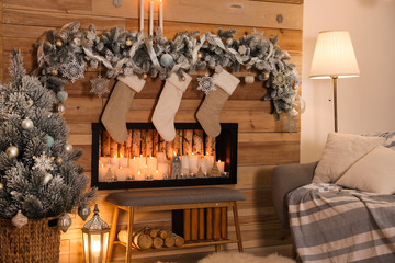 Festive room interior with decorative fireplace and Christmas stockings